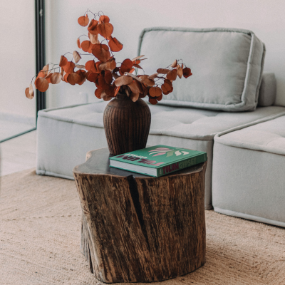 Wooden table with a boho vase and dried flowers, ideal for Tulum-inspired interior design.