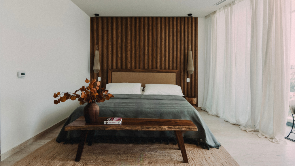 Tulum-Inspired Bedroom with Wooden Headboard and Boho Accents Modern bedroom with wooden headboard and boho decor in Tulum-inspired style.